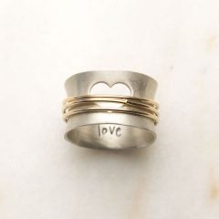 Brave Love spinner ring with a sterling silver band and gold-filled spinners and engraved with "brave love" on the inside