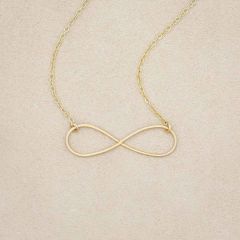A gold filled Forever, For Always Infinity Necklace, on a beige background