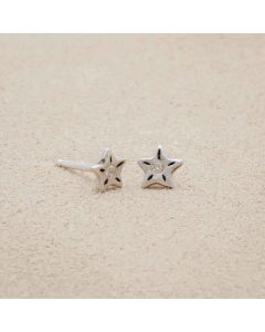 Your Spark Earrings, handcrafted in sterling silver, set with a 1.5mm cubic zirconia, sitting on beige background