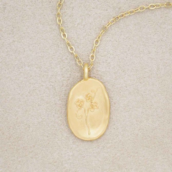 gold plated April birth flower necklace with an 18" gold filled link chain, on beige background
