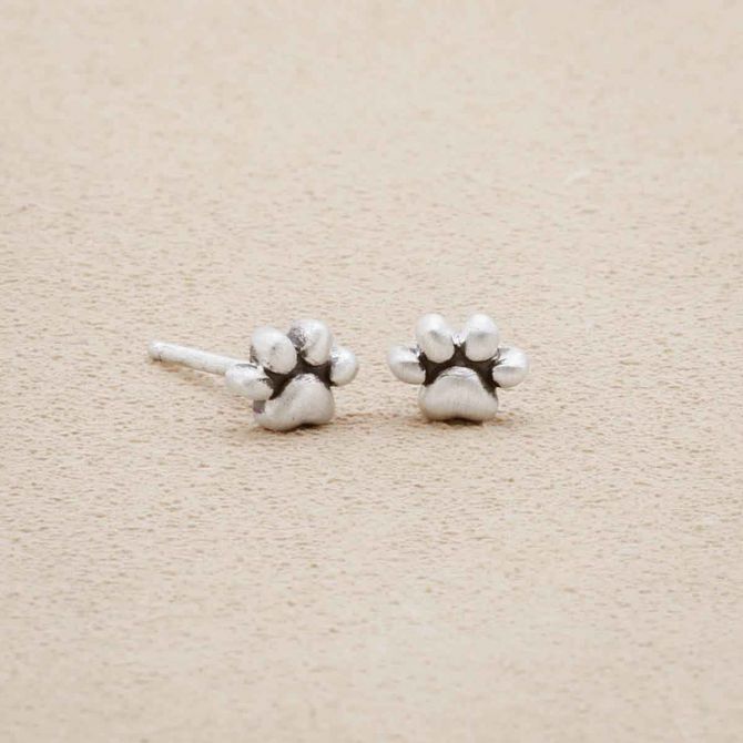 Furry Footprint Stud Earrings handcrafted in sterling silver, on suede