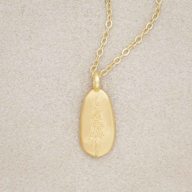 gold plated July birth flower necklace with an 18" gold filled link chain, on beige background