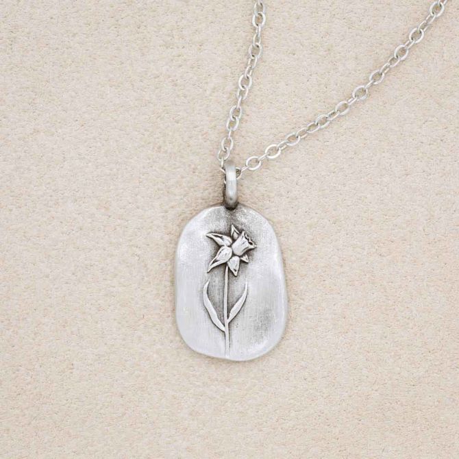 pewter March Birth Flower necklace with an 18" link chain, on beige background