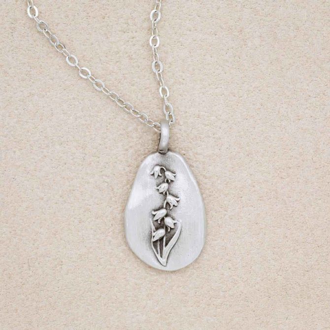 pewter May Birth Flower necklace with 18" link chain, on beige background