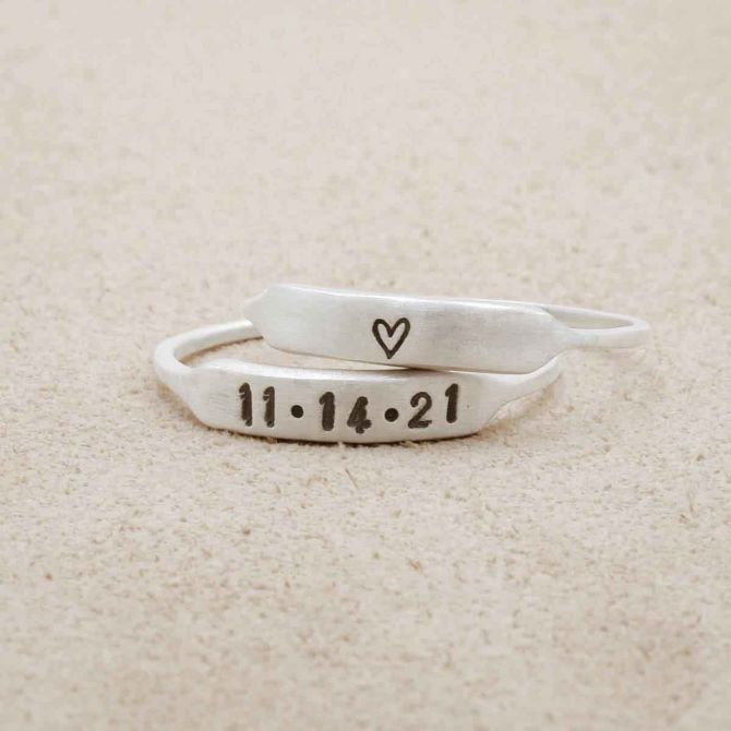 sterling silver Nameplate Stacking Ring on beige background