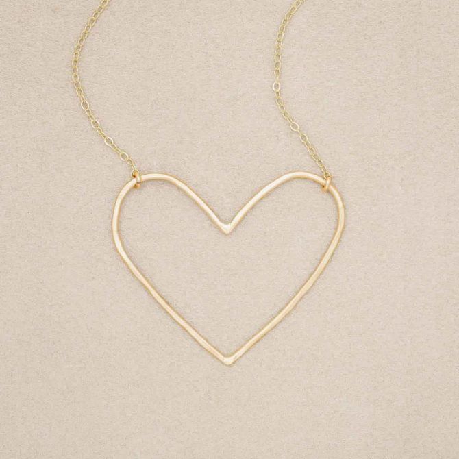 Gold filled Peaceful Heart Necklace on suede background