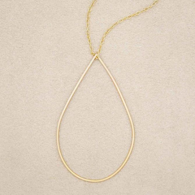 Sorrow and Joy Teardrop Necklace handcrafted in gold filled, on suede background 
