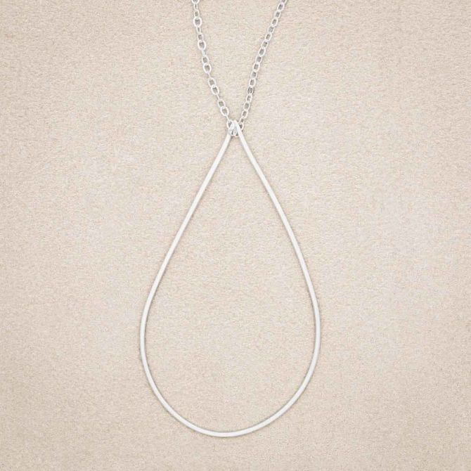 Sorrow and Joy Teardrop Necklace, handcrafted in sterling silver, on suede background
