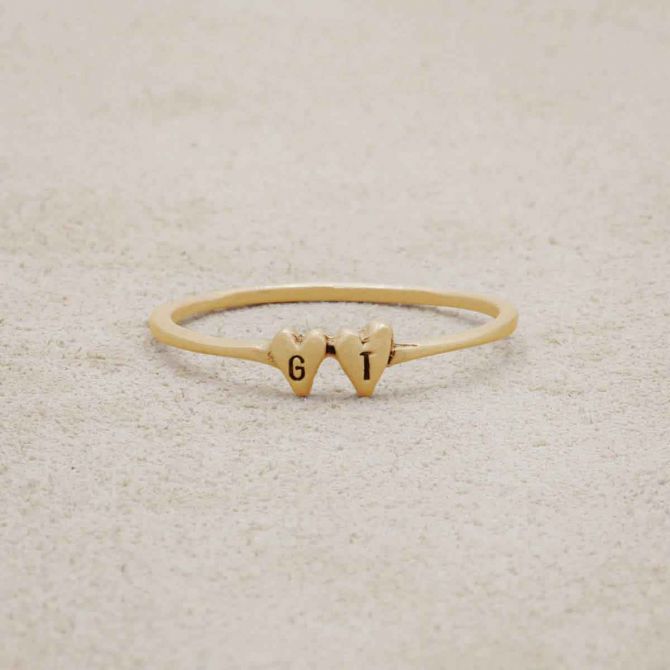 10k yellow gold Sweet Love Initial Ring - Two Hearts, personalized with two initials, on a beige background