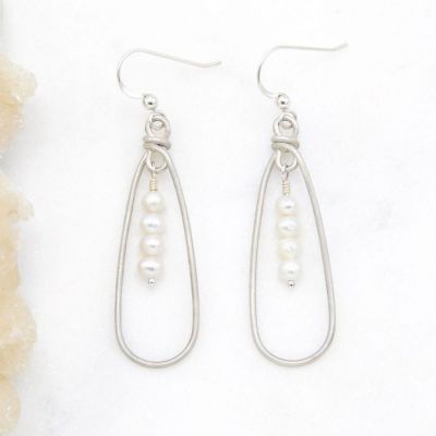 a mother's love pearl sterling silver earrings on marble background