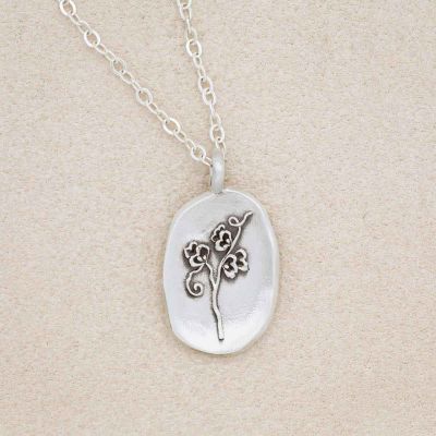 sterling silver April Birth flower necklace, on beige background