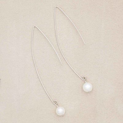 sterling silver artisan pearl earrings on marble background