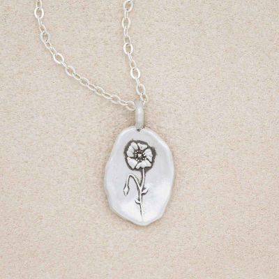sterling silver August birth flower necklace, on beige background