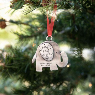 baby's first Christmas ornament of an elephant hand-molded and cast in fine pewter. personalized with up to two lines with a name, phrase or date being hung on a Christmas tree