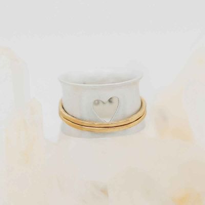 brave love® spinner ring {sterling silver & 10k gold} on white marble background