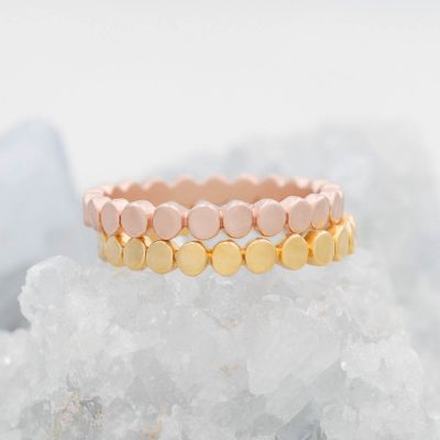 Circles in a line stacking ring handcrafted in rose gold-plated sterling silver with a satin finish 