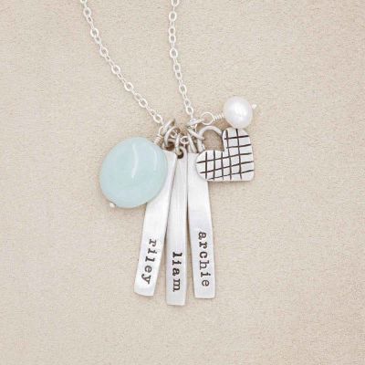Cross my heart necklace handcrafted in sterling silver with silver tags personalized with a special name hung next to a vintage freshwater pearl and an aqua stone