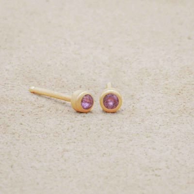 10K yellow gold Dainty Finespun Birthstone Stud Earrings - Small 2mm on a beige background