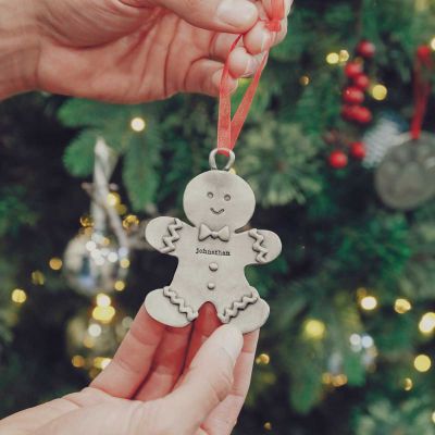 Gingerbread dad ornament hand-molded and cast in pewter with a personalized name hung on Christmas tree