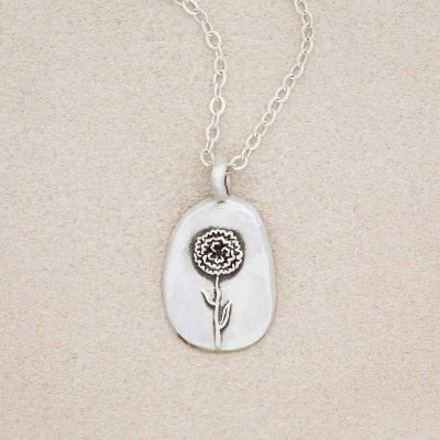 sterling silver January birth flower necklace, on beige background