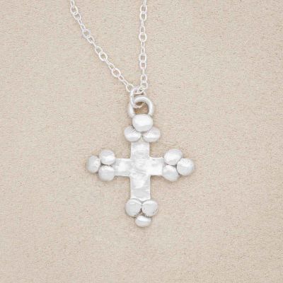 Known and loved cross necklace handcrafted in sterling silver with the cross charm hanging from choice of chain