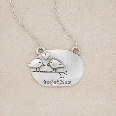 a pewter Better Together necklace, that has 2 love birds and the word "together" engraved on the front