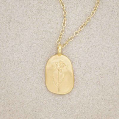 gold plated March birth flower necklace with an 18" gold filled link chain, on beige background