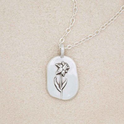 sterling silver March birth flower necklace, on beige background