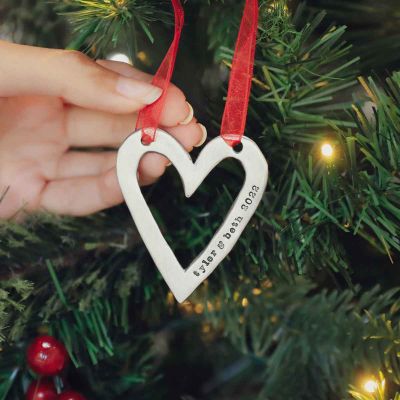 molded heart ornament handcrafted and cast in fine pewter personalized with a meaningful short phrase hanging on a Christmas tree