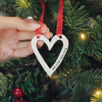 molded heart ornament handcrafted and cast in fine pewter personalized with a meaningful short phrase hanging on a Christmas tree