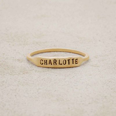 10k yellow gold personalized Nameplate Stacking Ring on a beige background
