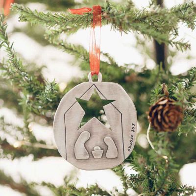nativity ornament hand-molded and cast in fine pewter personalized with a special name, phrase or date while hanging on a Christmas tree