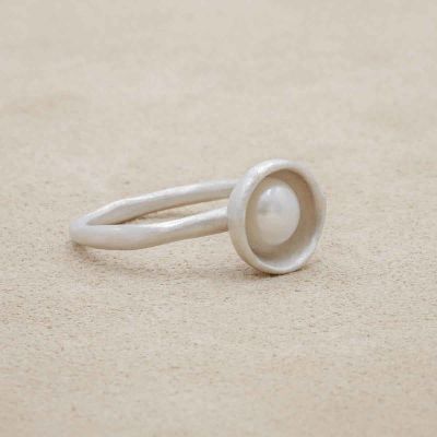 Nesting freshwater large pearl ring hand cast in sterling silver holding inside a large 6mm freshwater pearl 