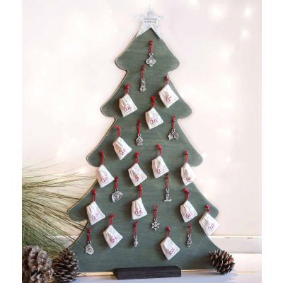 Wooden our Christmas tradition advent calendar  with 24 tiny pewter ornaments tucked in numbered muslin bags and hung from metal pegs topped with a pewter star hand-stamped with "Christmas is coming?"