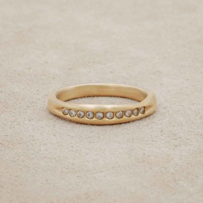 Passage ring handcrafted in 14k yellow gold and display of 1.5mm cubic zirconias 