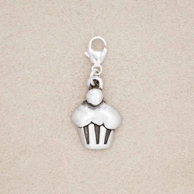 Peace, Love and Cupcakes Bracelet Charm cast in Sterling Silver, on a beige background