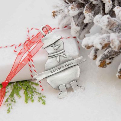 Snowman ornament hand-molded and cast in pewter hung from a sheer red ribbon and personalized with a phrase