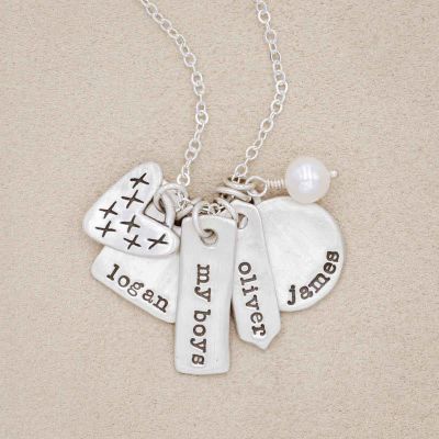 sterling silver storyteller necklace with personalized charms and freshwater pearl on beige background