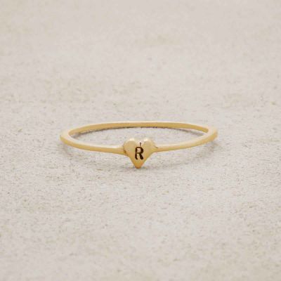 14k yellow gold Sweet Love Initial Ring - One Heart personalized with an initial, on a beige background
