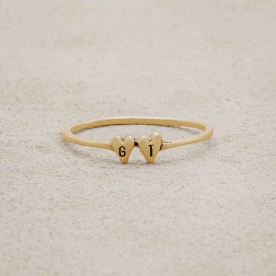 10k yellow gold Sweet Love Initial Ring - Two Hearts, personalized with two initials, on a beige background