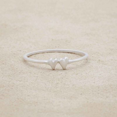 sterling silver sweet love ring with two hearts on a suede background