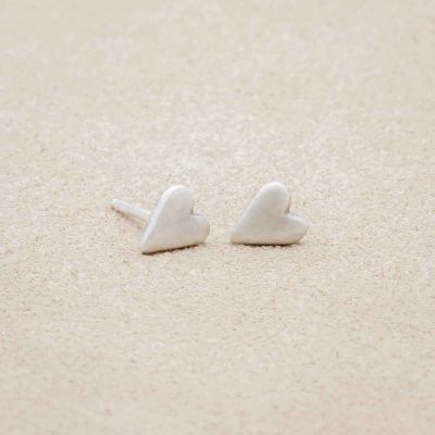 sterling silver tiny heart stud earrings with a matte brushed finish