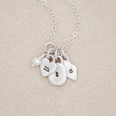Handcrafted sterling silver Wild about you initials necklace with personalized initials and a 3mm freshwater pearl, hanging from a sterling silver link chain