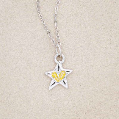your spark kids necklace, filled with glitter yellow epoxy, on a beige background